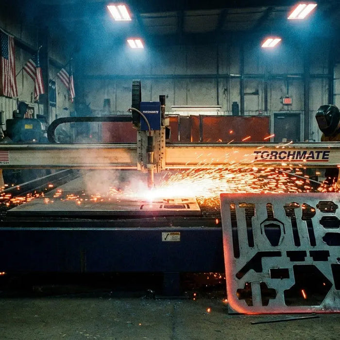 A CNC plasma cutter cutting a custom tool storage bracket from raw steel sheet in a dark industrial workshop, surrounded by bright orange sparks.