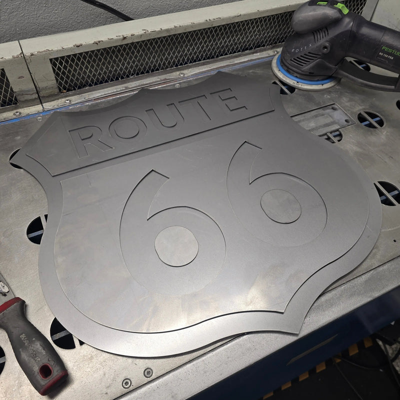 Laser-cut steel Route 66 shield being finished in the BOCO Custom shop