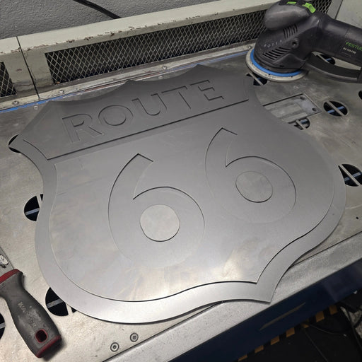 Laser-cut steel Route 66 shield being finished in the BOCO Custom shop