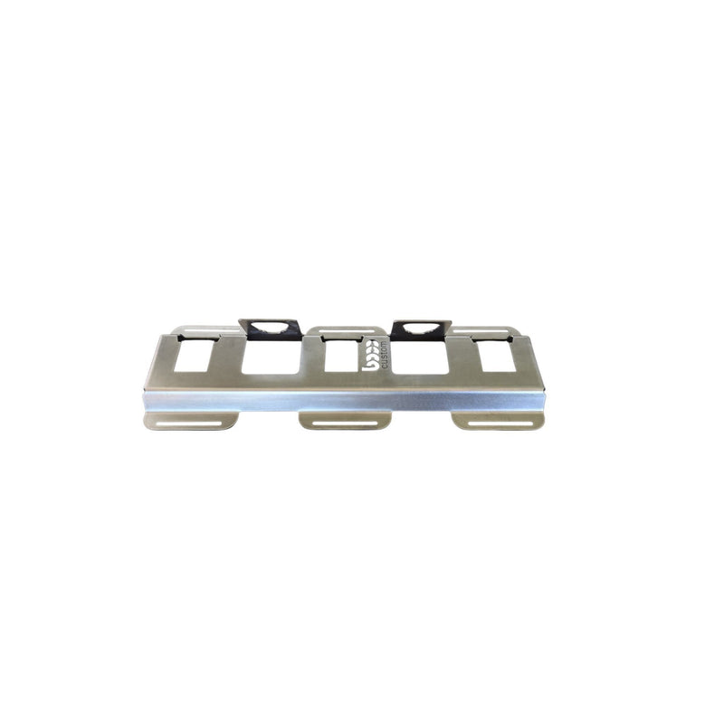 Empty 5-slot raw steel battery docking station for Milwaukee M18 and M12 batteries showing precision-cut mounting holes.
