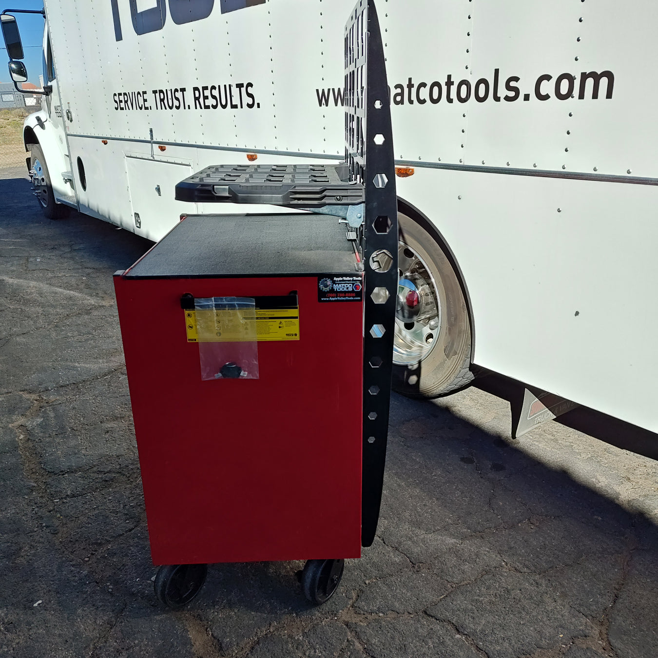 Heavy-duty laser-cut steel mounting plate attached to the side of a red Matco toolbox, featuring a modular Milwaukee Packout-compatible interface for shop organization.