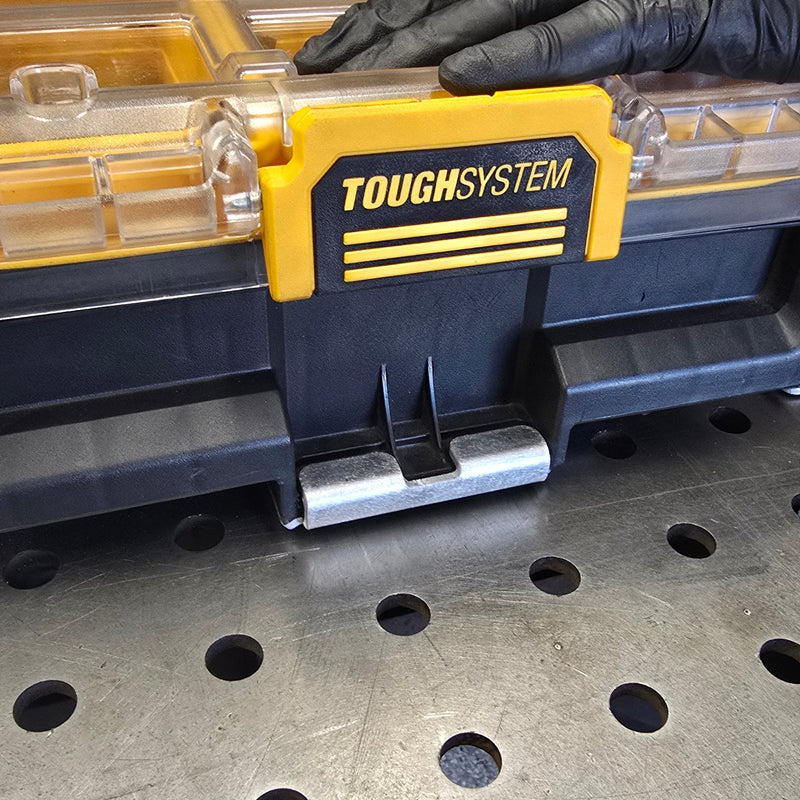 Toughsystem tool case held by a gloved hand on a metal surface