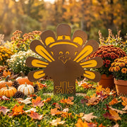 Steel turkey lawn decor staged in a fall garden with pumpkins and mums