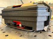 modular toolbox with red and black accents on a metal surface