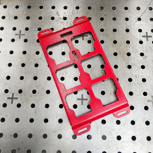 Red powder-coated Milwaukee Packout steel mounting plate on a professional welding table—heavy-duty 10-gauge alternative to Milwaukee 48-22-8496 for custom shop builds.