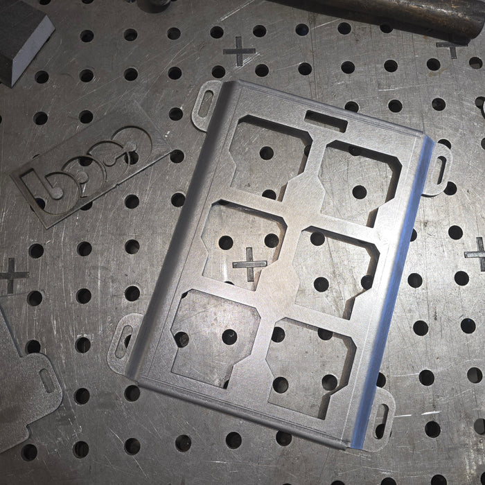 Metal mounting plate on a metal workbench