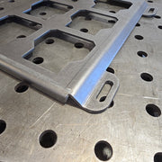 Metal bracket on a perforated metal surface