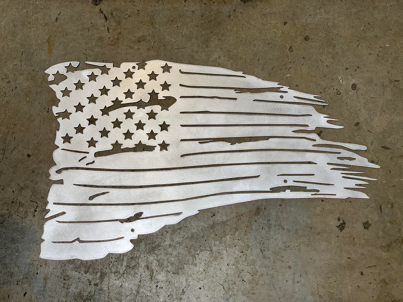 Metallic American flag cutout on a textured surface