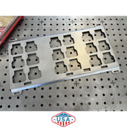Metal component with multiple holes on a pegboard background, featuring 'Made in the USA' label.