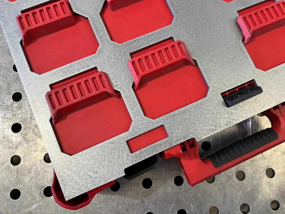 Red and gray tool organizer on a pegboard