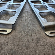 Close-up of two B-Grade Packout mounting plates: the unbent edge on the left and the bent edge on the right