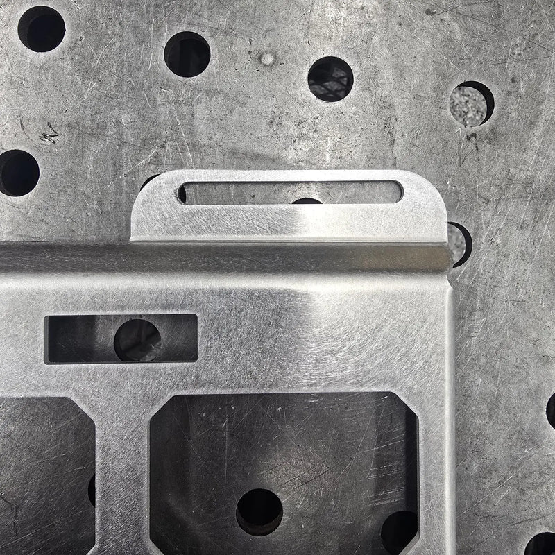 Close-up of imperfect mounting hole on clearance aluminum top row mount