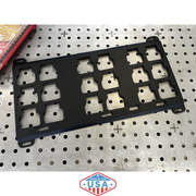 Black metal bracket on a pegboard with 'Made in the USA' label